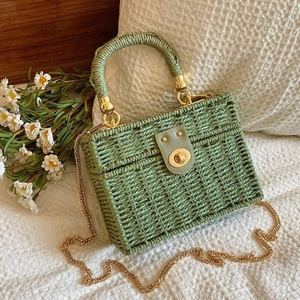 Sage green woven straw box bag with golden chain strap and circular top handle