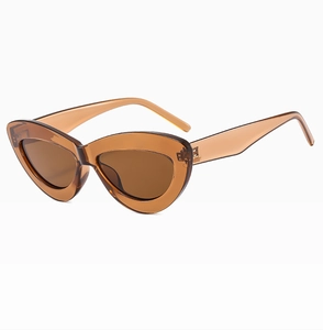 Macro detail of trendy amber brown cat-eye sunglasses with transparent resin frame and lenses