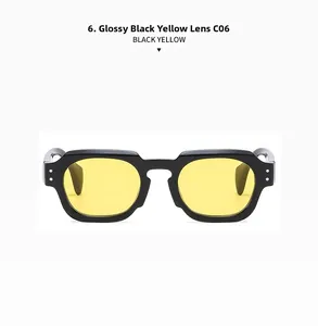 Detail of polygonal sunglasses with black frame, yellow lenses and silver rivets