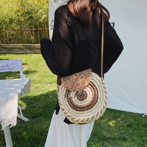 Bohemian round straw crossbody bag with vintage ethnic leather flap for summer beach trips