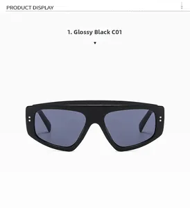 Detail view of bright black oversized sunglasses frame with silver dot accents and dark lenses