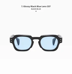 Close-up of polygon black sunglasses with light blue lenses and metal rivet details