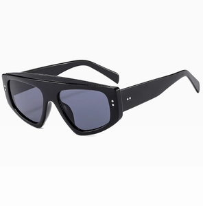 Detailed side view of black oversized sunglasses with thick frames and silver dot accents
