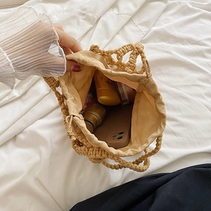 Bolso cubo de algodón tejido a mano con forro interno que muestra artículos de diario