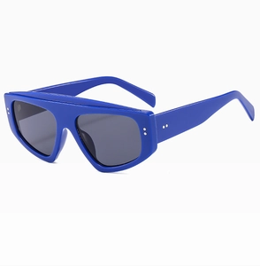 Detail of blue oversized flat top sunglasses featuring silver rivets on high-quality frames