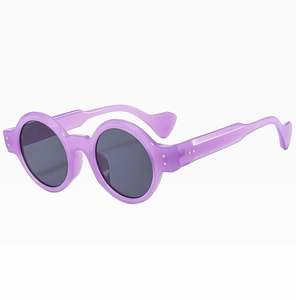 Detail of purple round sunglasses with trendy rice studs and heart-shaped temple tips