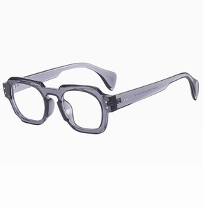 Detailed side view of grey translucent polygonal sunglasses with silver rivet accents
