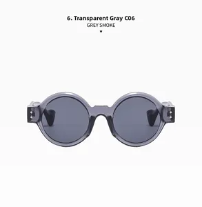 Detail of round punk sunglasses with transparent grey frames and dark grey smoke lenses