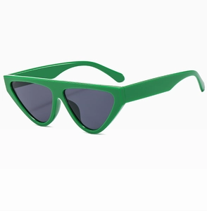 Detail view of green triangular cat-eye sunglasses with dark grey lenses and sturdy frame