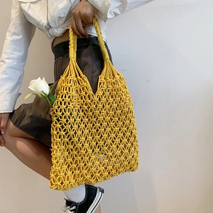 Handmade yellow macrame tote bag with floral accent for summer beach fashion