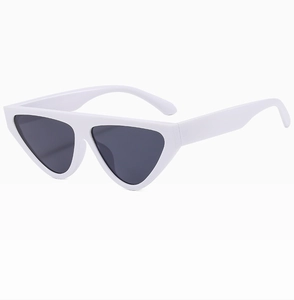 Detail view of stylish white cat-eye sunglasses with thick frames and dark lenses