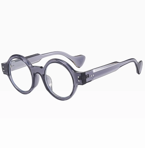 Detail view of round punk sunglasses with translucent grey frame and heart-shaped temple tips