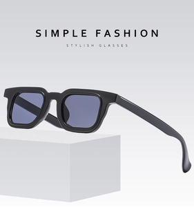 Detail view of stylish black square frame sunglasses on a clean geometric white block