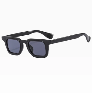 Detail of bold black square frame sunglasses featuring anti-slip temples and grey lenses
