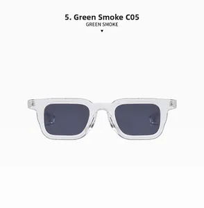 Detail view of transparent rectangular sunglasses with green smoke lenses and sleek frame