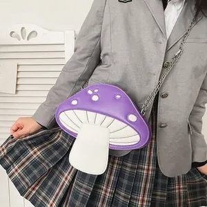 Quirky purple mushroom-shaped crossbody bag with silver chain strap worn by a model