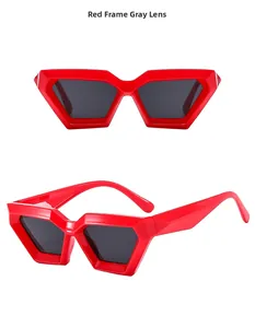 Detail view of bold red geometric punk sunglasses with dark gray UV lenses