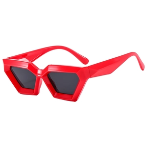 Bright red geometric polygonal sunglasses with punk-style thick frames and dark lenses
