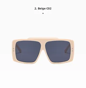 Detailed macro view of beige square oversized sunglasses with grey lenses and metal studs