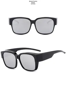 Detail view of black frame sunglasses with silver mirrored lenses for driving