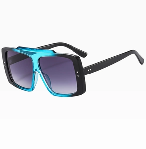 Detail of square two-tone sunglasses with blue translucent frames and rivet accents