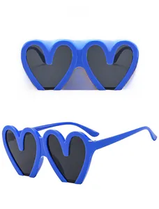 Detail of blue heart-shaped sunglasses with gray lenses showing front and side view