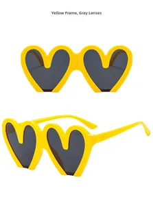 Detailed view of yellow heart-shaped sunglasses with protective dark gray lenses