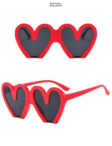 Detailed front and side view of heart-shaped red sunglasses with grey lenses