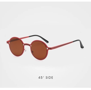 Detail view of round bicolored red and black metal frame sunglasses at a 45-degree angle