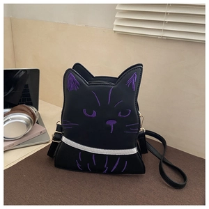 Detailed view of black cat-shaped crossbody bag with purple embroidery and golden hardware
