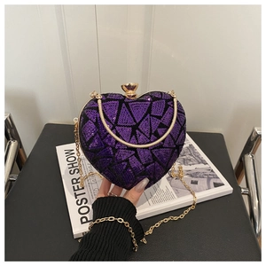Detail view of heart-shaped purple sequin evening bag with gold handle and chain strap
