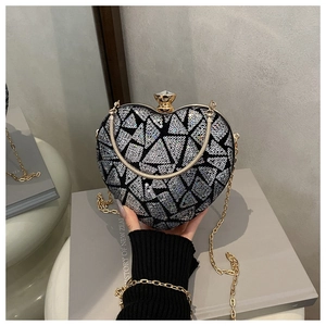 Macro shot of silver sequin heart bag with geometric patterns and golden crystal clasp