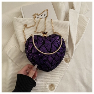 Detail of purple sequin heart-shaped evening clutch bag with gold chain strap