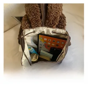 Detail view of large capacity interior with striped lining and plush rabbit ear design