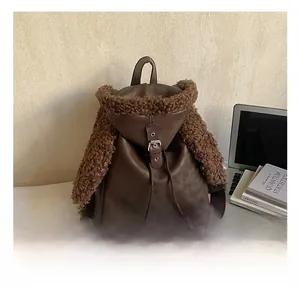 Detail of brown faux leather backpack with plush faux fur trim and buckle closure
