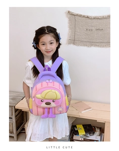 Detail of pink and purple cartoon backpack on a child with cute puppy design