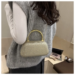 Sparkling gold rhinestone clutch bag featuring a vintage bamboo handle and chain strap
