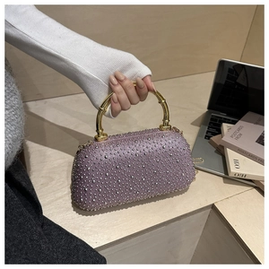 Detail of light purple evening bag with silver rhinestones and gold bamboo handle