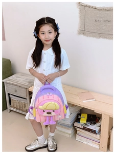Detail of pink and purple macaron-colored kid backpack with cute cartoon bear and 3D feet