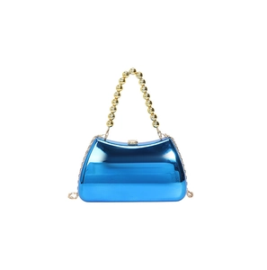 Detail of blue mirrored acrylic evening bag with gold beaded handle and metal chain
