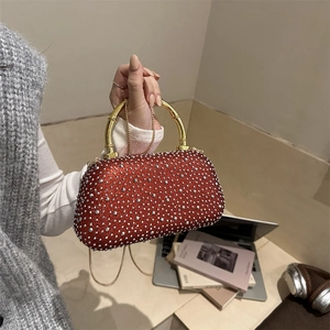 Sparkling red rhinestone evening clutch with a gold bamboo handle and chain strap