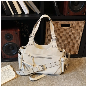 Detail of off-white vintage rivet bucket bag with metallic zipper pockets and punk style