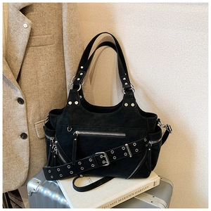 Detail of black motorcycle bucket bag with silver hardware and studded eyelet shoulder strap