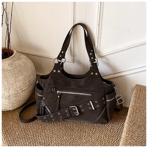 Detail of dark brown vintage faux leather shoulder bag with metallic studs and zippers