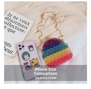 Rainbow acrylic beaded mini bag with gold chain strap next to a phone for size scale