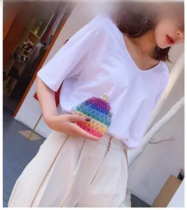 Close-up of rainbow acrylic beaded mini evening bag with gold metal clasp and chain