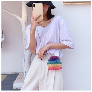 Close-up of a handmade rainbow acrylic beaded crossbody bag with a gold metal clasp and chain