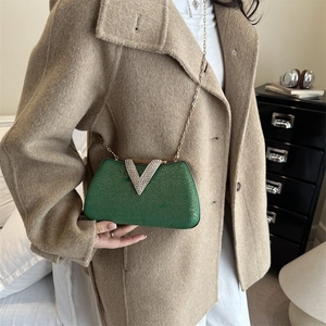 Emerald green evening box bag with rhinestone V-clasp and elegant gold chain strap