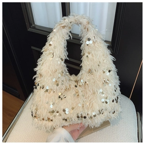 Detailed view of the fluffy white hobo bag with sparkling golden sequins and plush texture