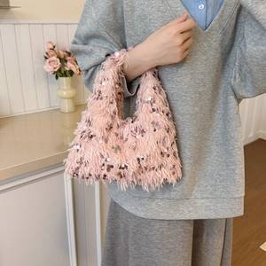 Elegant pink faux fur bucket bag with metallic sequins and integrated handle for women